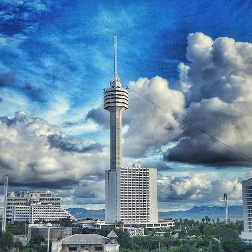 Pattaya Park observation tower against dramatic cumulus clouds on Pratumnak hill