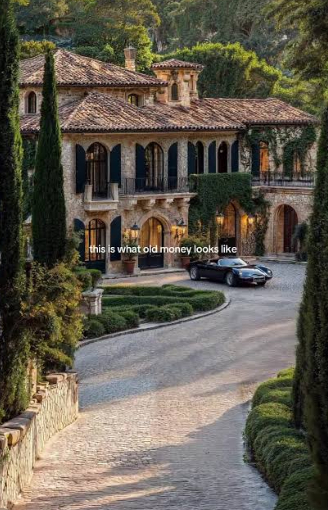 Mediterranean stone villa with cypress trees and cobblestone driveway — an example of an irreplaceable heritage property the world's wealthiest families hold across generations.
