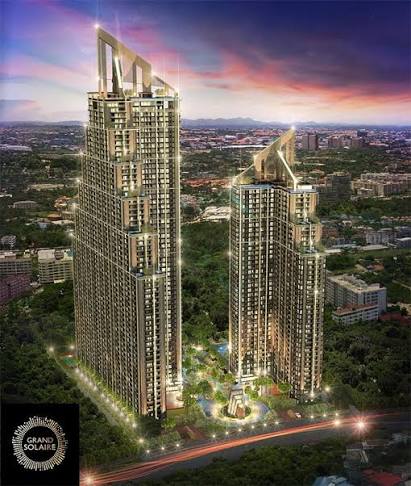 Grand Solaire Pattaya twin-tower render with illuminated crowns at dusk